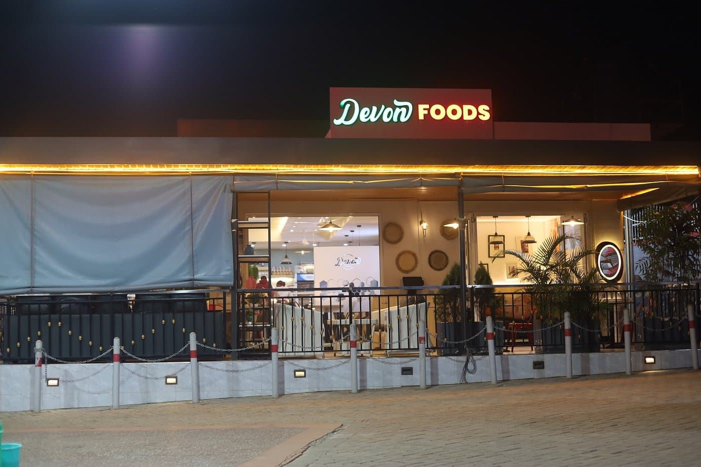 A Devon Foods restaurant lit up in the evening